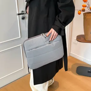 Minimalist grey quilted laptop sleeve with shockproof padding and dual zipper design