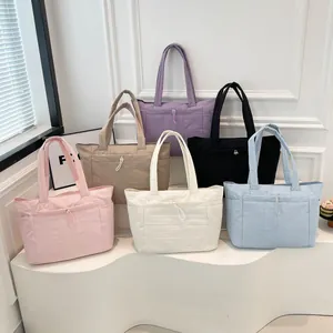 Quilted tote bags set in six colors showing lightweight fabric and drawstring pocket