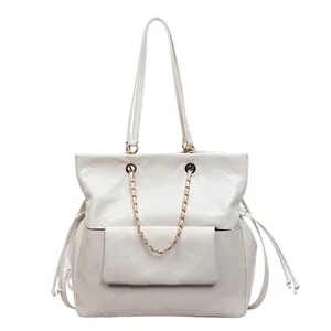 Creamy white quilted tote bag with golden chain and drawstring detail for women