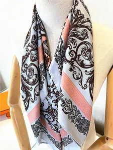 Detail of 90cm floral twill silk scarf with hand-rolled edges on a model