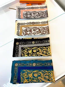 Close-up of four stacked 90cm silk scarves featuring baroque floral patterns and Greek keys