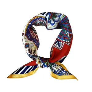 Macro shot of 53cm silk scarf showing vibrant paisley patterns and smooth fabric texture