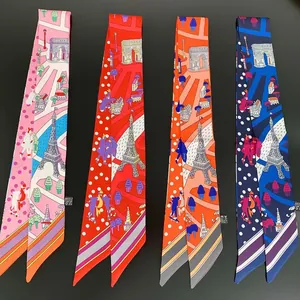 Detailaufnahme schmaler Twilly-Seidentücher mit Eiffelturm-Print in vier Farbtönen