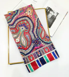 Detail of bohemian paisley and striped silk scarf showing vibrant colors and smooth texture