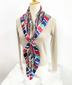 Detail of bohemian paisley silk scarf with vibrant floral patterns and satin texture