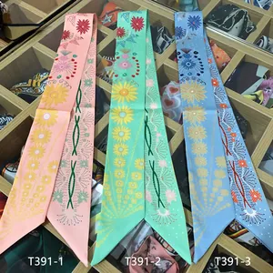 Detailed view of floral daisy silk twilly scarves for bag handles and hair styling