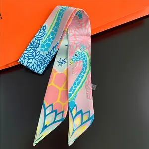 Detailed close-up of a colorful giraffe print silk twilly scarf for handbags and hair