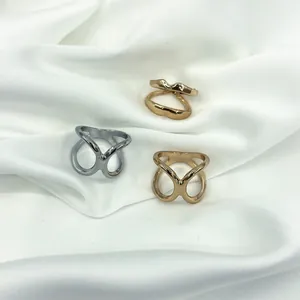 Close-up of geometric V-shaped pearl silk scarf rings in silver, gold, and rose gold finishes