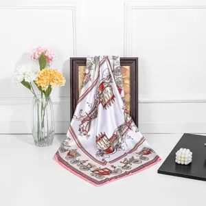 Classic 90cm royal carriage silk square scarf in cream and pink on a wooden frame