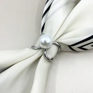 Close-up of silver-tone three-ring V-shape scarf clip with a large white pearl center