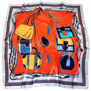 Elegant 90cm square silk scarf featuring luxury handbag patterns on vibrant orange background