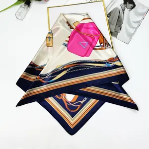 Close-up of elegant 90cm silk scarf featuring geometric chain patterns and vibrant prints