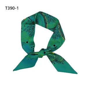 Vue détaillée du foulard en soie vert foncé noué avec des motifs artistiques abstraits