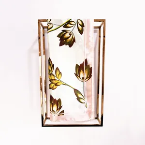 Detail of satin silk scarf featuring autumn leaf pattern and elegant pink borders