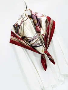 Close-up of silk scarf featuring classic horse bit patterns and soft glossy finish