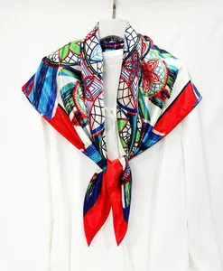 Detailed close-up of a 90cm floral silk scarf tied elegantly on a white collar shirt