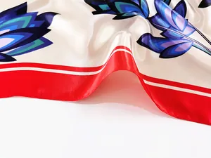 Detail of silk-satin scarf showing vibrant lotus pattern and glossy fabric texture