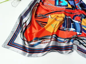 Detailed flat lay of luxury satin scarf with vintage horse bridle and chain patterns