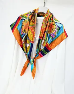 Detail of colorful hand-painted floral silk scarf draped on white shirt background
