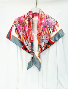 Detail of elegant hand-painted floral silk scarf with abstract patterns on white shirt