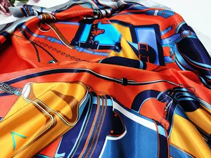 Detailed close-up of silk scarf showing equestrian patterns and luxury leather strap prints