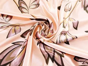 Macro shot of 90cm square silk scarf showing soft pink maple leaf patterns and glossy drape