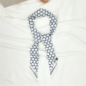 Long silk twilly scarf with blue geometric square pattern and pointed ends for handbags