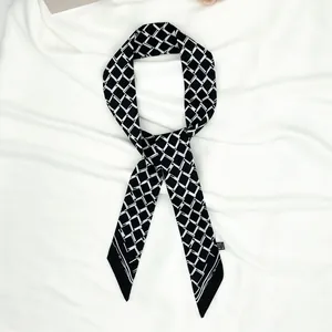 Detail of black and white geometric pattern twilly silk scarf with pointed ends and care label
