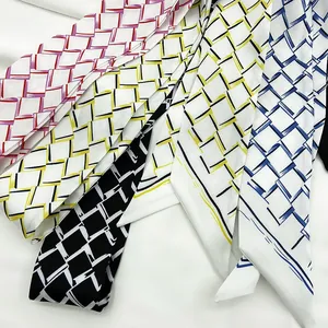 Detail of geometric pattern twilly scarves in red, yellow, black and blue colorways