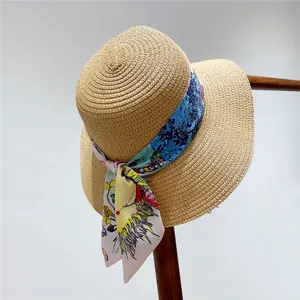 Close-up of natural straw hat texture featuring a colorful butterfly floral ribbon detail