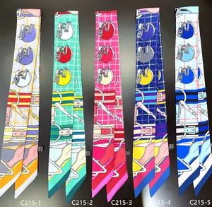 Detailed flat lay of five colorful twilly scarves with cartoon horse and buckle patterns