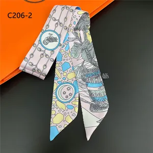 Detail of artistic floral pattern on 100% polyester twilly scarf with owl and moon motifs