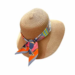 Straw sun hat for women with colorful printed ribbon and wide brim for summer vacations