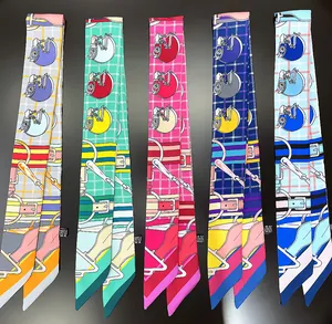Detailed view of various colorful horse-themed twilly scarves in a silk-like finish