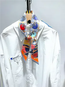 Close-up of a colorful equestrian print twilly scarf tied on a white shirt collar