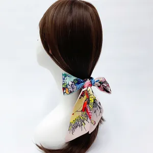 Colorful floral silk scarf tied to a ponytail on a model with white background