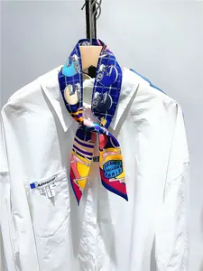 Detail of royal blue horse print silk twilly tied on a white shirt collar