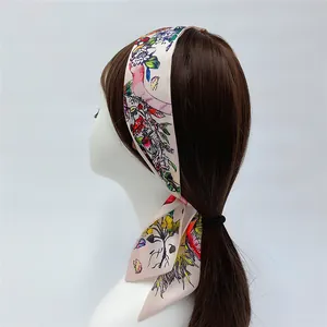 Floral butterfly print satin scarf tied as a hair ribbon on a braided hairstyle