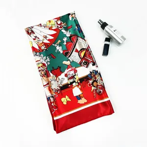 Detail of silk scarf with ethnic print, green and red patterns and vibrant border