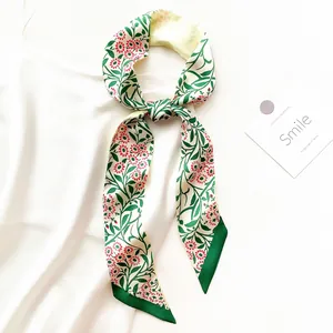 Floral print twilly scarf with green leaves and red daisies on cream silk-like fabric