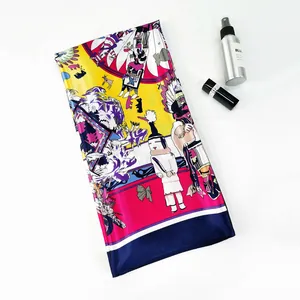Detail of colorful satin scarf with tribal art print beside elegant cosmetic props