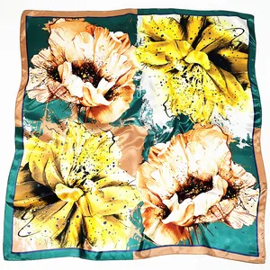 Satin floral square scarf featuring bold yellow blossoms and dark green geometric patterns