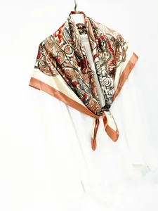 Close-up of vintage paisley pattern on a silky 90cm square scarf with champagne borders