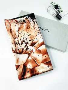 Elegant floral silk scarf neatly folded in a premium gift box with queen lettering