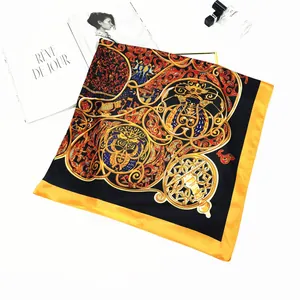 Detailed macro view of vintage silk scarf with golden patterns and sleek orange border