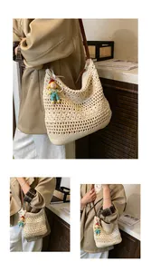 Detail of hand-crocheted beige bag with geometric patterns and brown leather strap