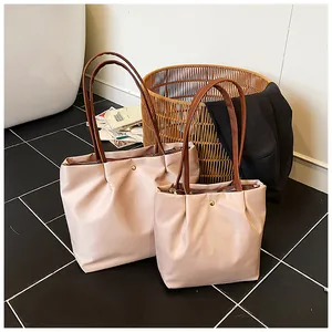 Detailed comparison of large and medium pink waterproof nylon tote bags with zip closure