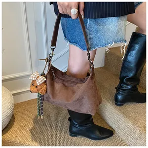 Brown suede shoulder bag with deep brown leather strap and cute bear charm detail