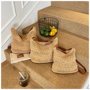 Detailed close-up of three sizes of hand-woven hobo bags with floral crochet patterns