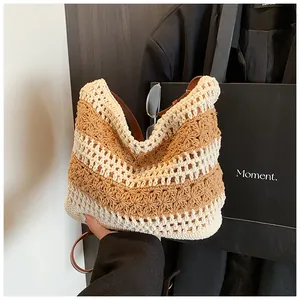 Detail of hand-woven striped crochet shoulder bag with premium brown leather strap